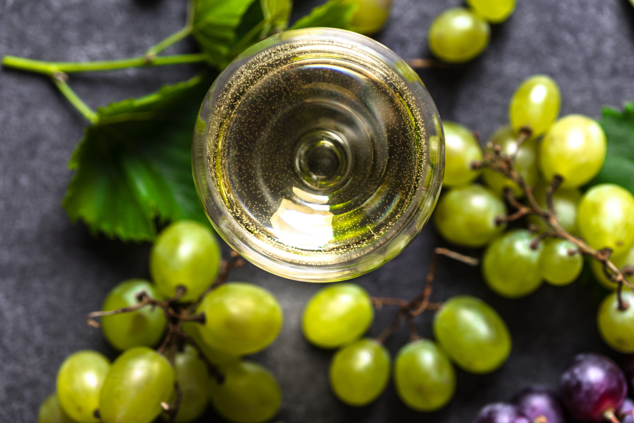 Fresh,Green,Grape,And,White,Wine,Glass,,Closeup,,Top,View
