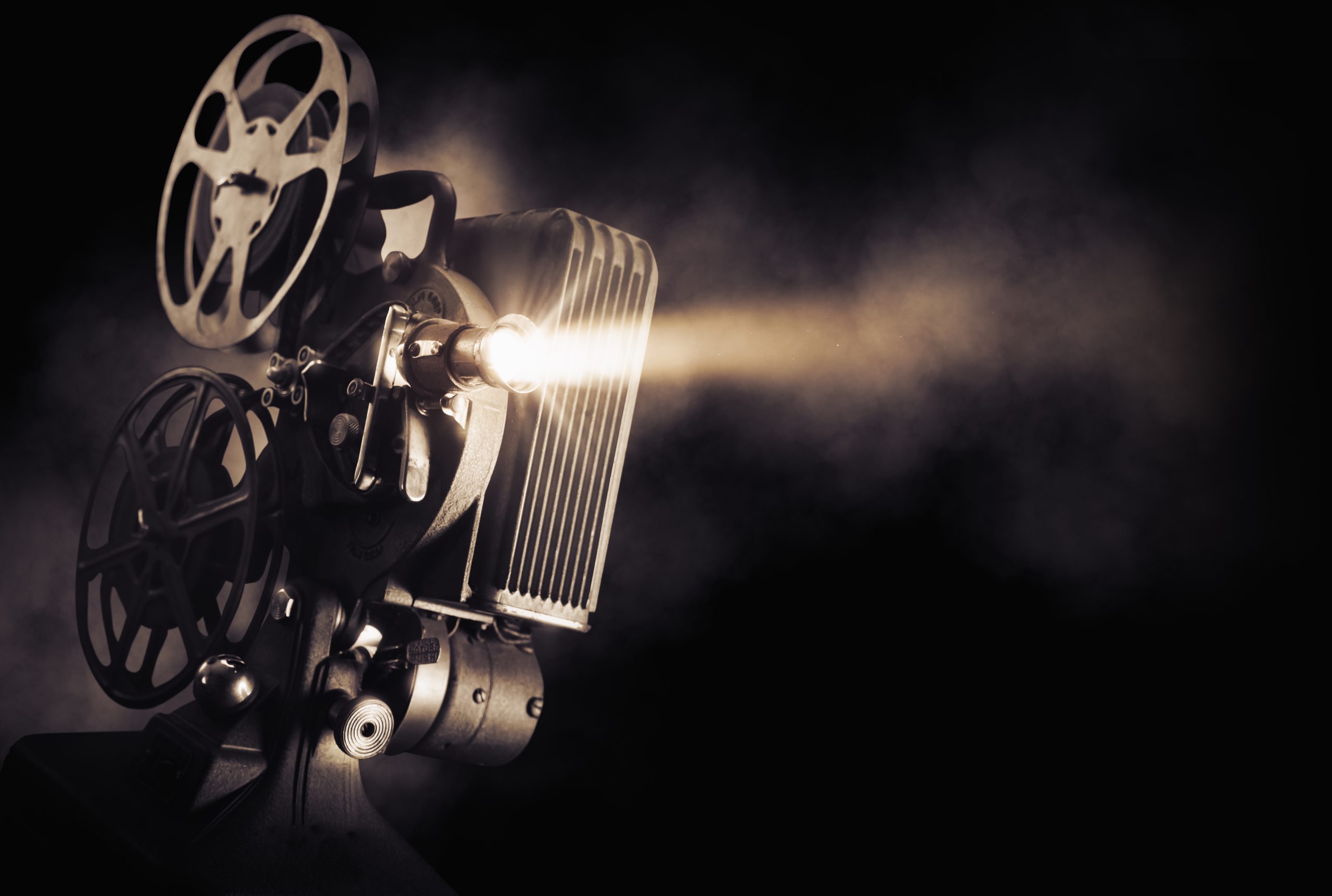 Movie,Projector,On,A,Dark,Background,With,Light,Beam,/