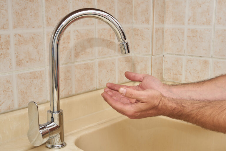 Male,Hand,Under,A,Faucet,In,A,Kitchen