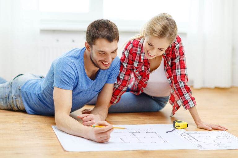 Repair,,Building,,Renovation,And,Home,Concept,-,Smiling,Couple,Looking