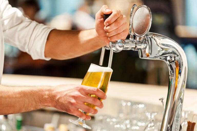 Pouring,Fresh,Beer.,Close-up,Of,Young,Bartender,Pouring,Beer,While