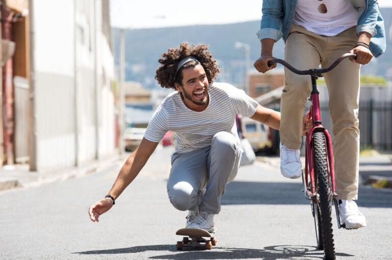 Closeup,Of,A,Happy,Young,Man,Skateboarding,With,Help,Of