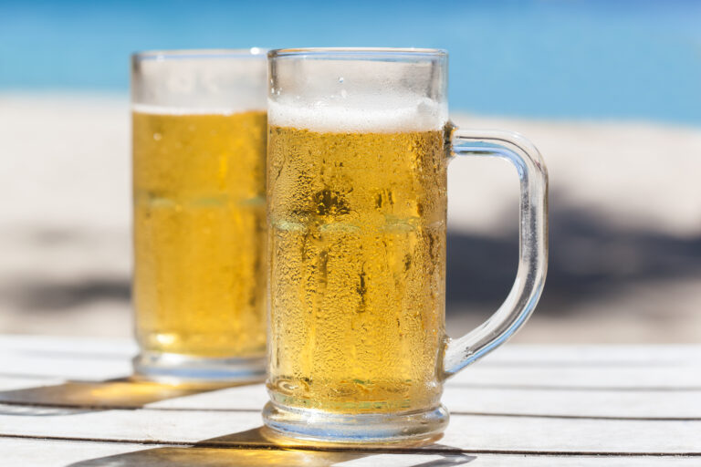 Two,Glasses,Of,Beer,On,A,Beach