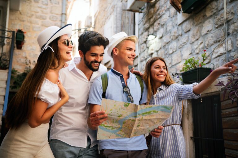 Happy,Traveling,Friends,Tourists,Sightseeing,With,Map,In,Hand
