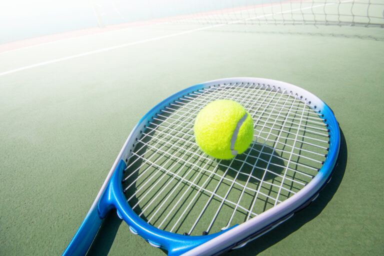 Tennis,Racket,And,Tennis,Ball,On,Court.