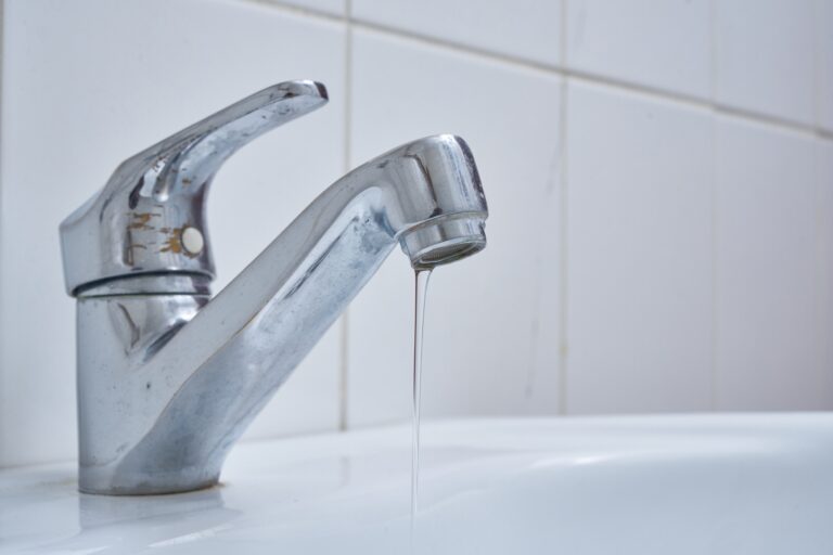 Chrome,Bathroom,Faucet,And,White,Sink,Closeup,During,A,Water